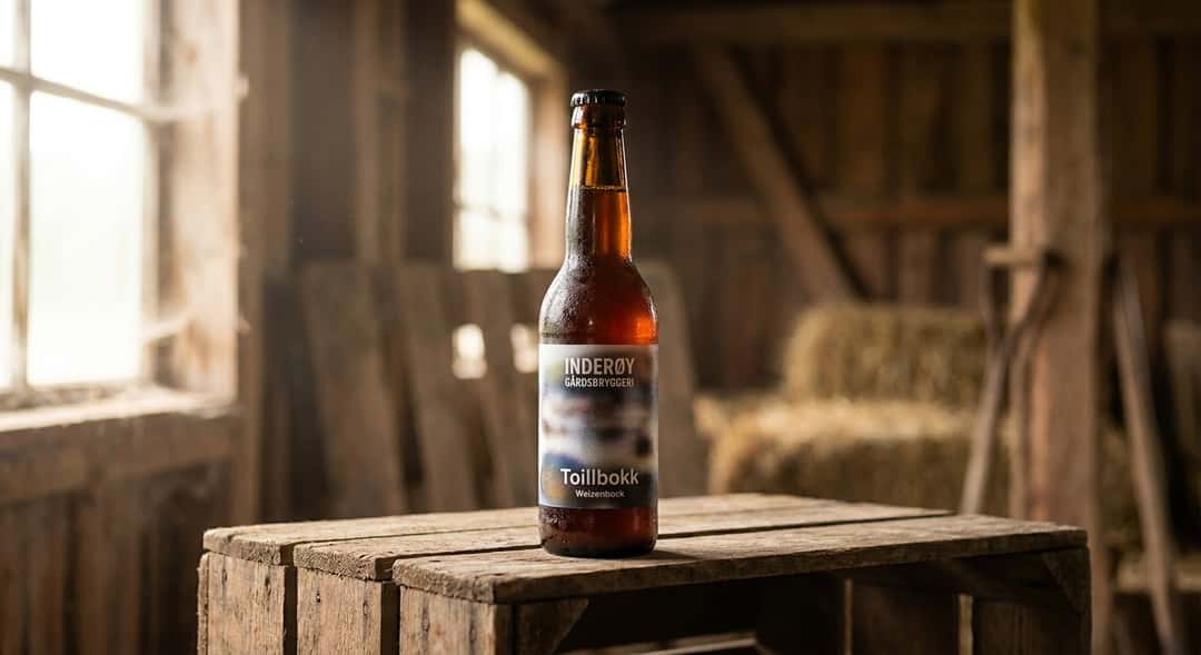 A bottle of Inderøy Gårdsbryggeri Toillbokk Weizenbock placed on a wooden crate, rustic barn setting in the background,